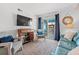Comfortable living room area with stylish decor, a large-screen TV and outdoor views at 720 North Waccamaw Dr. # 312, Murrells Inlet, SC 29576