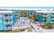 Stunning view of the community pool deck with lounge chairs, palm trees, and walkways at 720 North Waccamaw Dr. # 312, Murrells Inlet, SC 29576