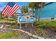 Charming entrance sign surrounded by lush landscaping and greenery at The Beach House at 720 North Waccamaw Dr. # 312, Murrells Inlet, SC 29576