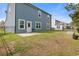 Large backyard with patio, fresh grass, and a black fence at 808 Wild Leaf Loop, Conway, SC 29526