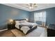 Stylish main bedroom with tray ceiling, bedside lamps, fan, and en-suite bathroom at 808 Wild Leaf Loop, Conway, SC 29526