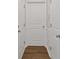 Bright hallway features hardwood floors, white doors, and trim at 808 Wild Leaf Loop, Conway, SC 29526