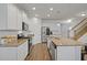 A modern kitchen featuring stainless steel appliances, granite countertops, and hardwood flooring at 808 Wild Leaf Loop, Conway, SC 29526