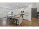 A well-lit kitchen with a center island, stainless steel appliances, and hardwood floors at 808 Wild Leaf Loop, Conway, SC 29526