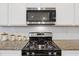A well-equipped kitchen featuring a gas range, granite countertops, and white subway tile at 808 Wild Leaf Loop, Conway, SC 29526