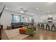 A living room featuring an open-concept to the kitchen area, hardwood floors, and modern design at 808 Wild Leaf Loop, Conway, SC 29526