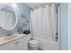 Well-lit bathroom with a vanity, toilet, and bathtub with a shower curtain at 811 N Ocean Blvd. # 401, Surfside Beach, SC 29575
