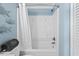 Clean bathroom features a white tub and shower combo with blue walls and decorative fish art at 811 N Ocean Blvd. # 401, Surfside Beach, SC 29575