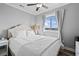 Comfortable bedroom with a ceiling fan, carpet, and plenty of natural light at 811 N Ocean Blvd. # 401, Surfside Beach, SC 29575