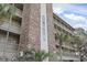 Exterior view of the building with palm trees and ocean views at 811 N Ocean Blvd. # 401, Surfside Beach, SC 29575