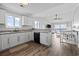 Bright, open kitchen with white cabinets, granite countertops, and stainless steel appliances at 811 N Ocean Blvd. # 401, Surfside Beach, SC 29575