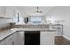 Kitchen with stone countertops, white cabinets, seating and an ocean view at 811 N Ocean Blvd. # 401, Surfside Beach, SC 29575
