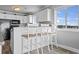 Kitchen features white cabinetry, a breakfast bar, and modern appliances at 811 N Ocean Blvd. # 401, Surfside Beach, SC 29575