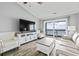 Cozy living area featuring a large television, comfortable seating, and access to a scenic balcony at 811 N Ocean Blvd. # 401, Surfside Beach, SC 29575