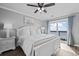 Bright main bedroom featuring a ceiling fan, balcony access, and wood-look flooring at 811 N Ocean Blvd. # 401, Surfside Beach, SC 29575