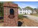 Elegant brick sign displaying the address, complemented by a view of the traditional home at 817 Evans Rd., Marion, SC 29571