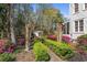Lush backyard garden with verdant shrubbery, mature trees, flowering azaleas, and quaint garden shed at 817 Evans Rd., Marion, SC 29571