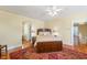 Bedroom with wooden bed frame, ceiling fan, decorative rug, and warm, inviting lighting at 817 Evans Rd., Marion, SC 29571