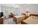 Cozy bedroom featuring two beds, a desk, and warm lighting with ample sunlight at 817 Evans Rd., Marion, SC 29571
