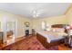 Bedroom with fireplace, wooden bed frame, ceiling fan, and patterned rug at 817 Evans Rd., Marion, SC 29571