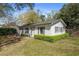 Charming cottage exterior with green lawn and privacy hedges at 817 Evans Rd., Marion, SC 29571
