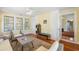 Sunlit sitting room with wicker furniture, hardwood floors, and bright natural light at 817 Evans Rd., Marion, SC 29571