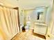 Functional bathroom features a sink with vanity, toilet, and shower with curtain at 8560 Queensway Blvd. # 304, Myrtle Beach, SC 29572