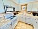 Well-equipped kitchen boasting white cabinets, stainless steel appliances, and speckled granite countertops at 8560 Queensway Blvd. # 304, Myrtle Beach, SC 29572