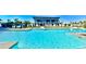 Resort-style pool featuring plenty of lounge chairs with umbrellas and a modern clubhouse at 8560 Queensway Blvd. # 304, Myrtle Beach, SC 29572
