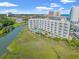 Aerial view of large condo building with waterfront pool and hot tub at 9400 Shore Dr. # 725, Myrtle Beach, SC 29572