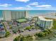Beautiful aerial view of oceanfront resort featuring tennis courts, pool, and private beach access at 9400 Shore Dr. # 725, Myrtle Beach, SC 29572