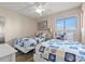 Inviting bedroom featuring two twin beds with seashell-themed bedding and ample natural light at 9400 Shore Dr. # 725, Myrtle Beach, SC 29572