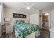 Comfortable primary bedroom featuring a tropical themed bedspread and an ensuite bathroom at 9400 Shore Dr. # 725, Myrtle Beach, SC 29572