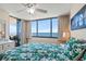 Bright primary bedroom with ocean views, balcony access, and a tropical themed bedspread at 9400 Shore Dr. # 725, Myrtle Beach, SC 29572