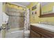 Yellow bathroom complete with a shower and vanity, adding a pop of color to a functional space at 9620 Shore Dr. # 307, Myrtle Beach, SC 29572
