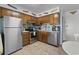 Functional kitchen equipped with stainless steel appliances and wooden cabinetry, maximizing space and efficiency at 9620 Shore Dr. # 307, Myrtle Beach, SC 29572