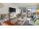 Cozy living room featuring a television and access to a balcony, perfect for relaxation and entertainment at 9620 Shore Dr. # 307, Myrtle Beach, SC 29572