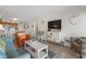 Bright, open living room with comfortable seating, a flat screen TV, and tiled flooring at 9620 Shore Dr. # 307, Myrtle Beach, SC 29572