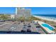 Aerial view of the condo building showing the pool and nearby beach and parking at 9820 Queensway Blvd. # 607, Myrtle Beach, SC 29572