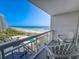 Balcony featuring seating and stunning ocean views, overlooking a beach and nearby buildings, offering a relaxing outdoor space at 9820 Queensway Blvd. # 607, Myrtle Beach, SC 29572