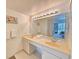 Bathroom featuring double sinks and a large mirror with vanity lighting that leads to bedroom at 9820 Queensway Blvd. # 607, Myrtle Beach, SC 29572