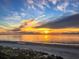 Gorgeous sunset over the ocean, casting a golden glow on the tranquil beach and sky at 9820 Queensway Blvd. # 607, Myrtle Beach, SC 29572