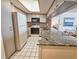 Well-equipped kitchen with white appliances, granite countertops, and access to the dining area at 9820 Queensway Blvd. # 607, Myrtle Beach, SC 29572