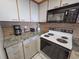 Cozy kitchen featuring granite countertops, white cabinets, and modern appliances at 9820 Queensway Blvd. # 607, Myrtle Beach, SC 29572