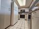 Efficient kitchen with white appliances and ample cabinet space, complemented by tile flooring at 9820 Queensway Blvd. # 607, Myrtle Beach, SC 29572