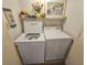 Laundry room area featuring a white top-load washing machine and a white dryer with wire shelving above at 9820 Queensway Blvd. # 607, Myrtle Beach, SC 29572
