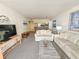 Cozy living room featuring neutral tones, comfortable sofas, and an open layout to kitchen at 9820 Queensway Blvd. # 607, Myrtle Beach, SC 29572