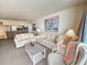 Relaxing living room with soft lighting and ocean themed paintings, and a view of the kitchen at 9820 Queensway Blvd. # 607, Myrtle Beach, SC 29572