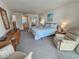 A beautifully decorated bedroom with a comfortable chair and dresser with great natural light at 9820 Queensway Blvd. # 607, Myrtle Beach, SC 29572