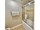 Bathroom with tiled shower featuring sliding glass doors and a towel rack at 9994 Beach Club Dr. # 408, Myrtle Beach, SC 29572